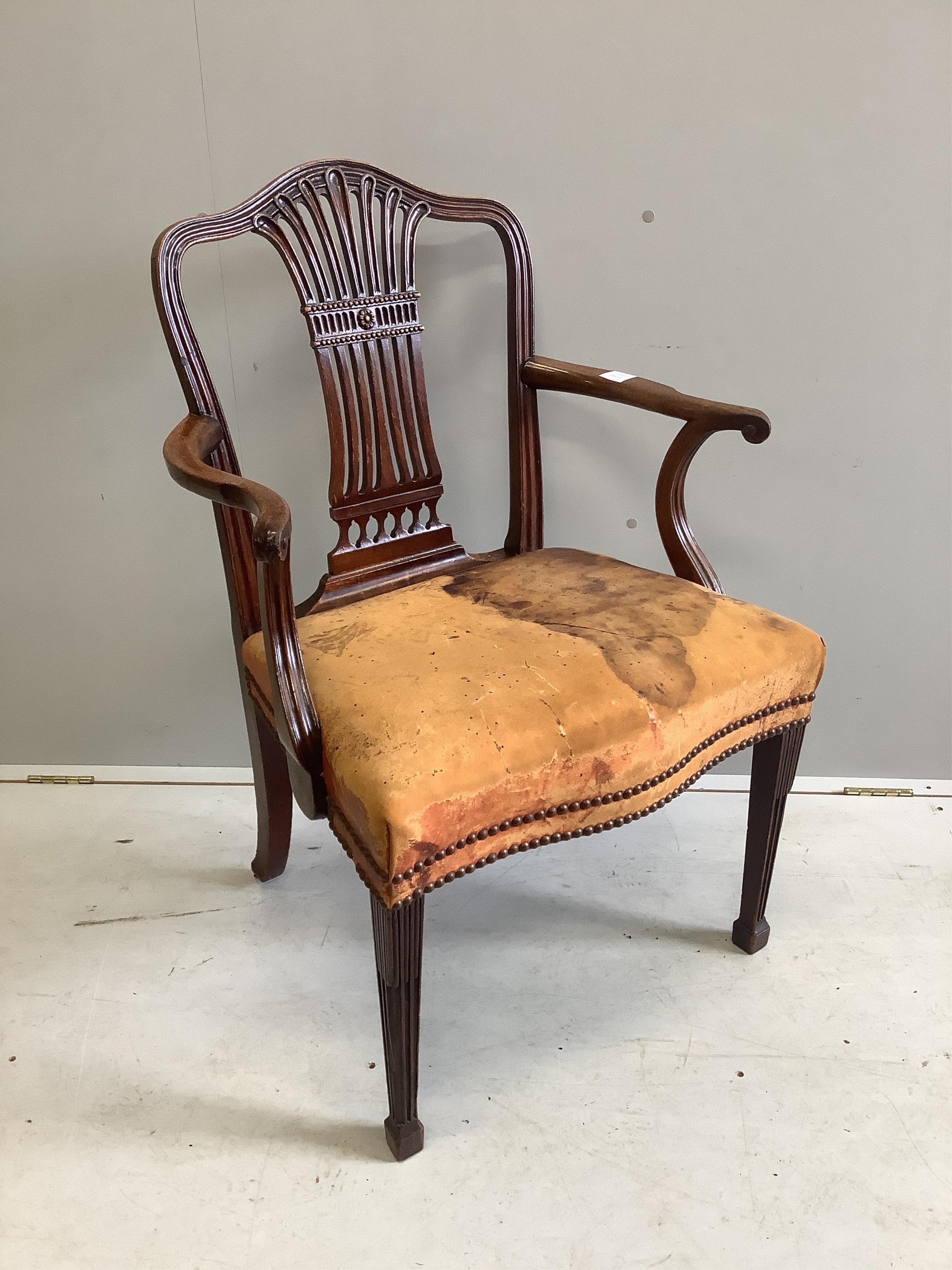 A George III mahogany elbow chair, stained leather seat, width 63cm, depth 49cm, height 95cm. Condition - fair